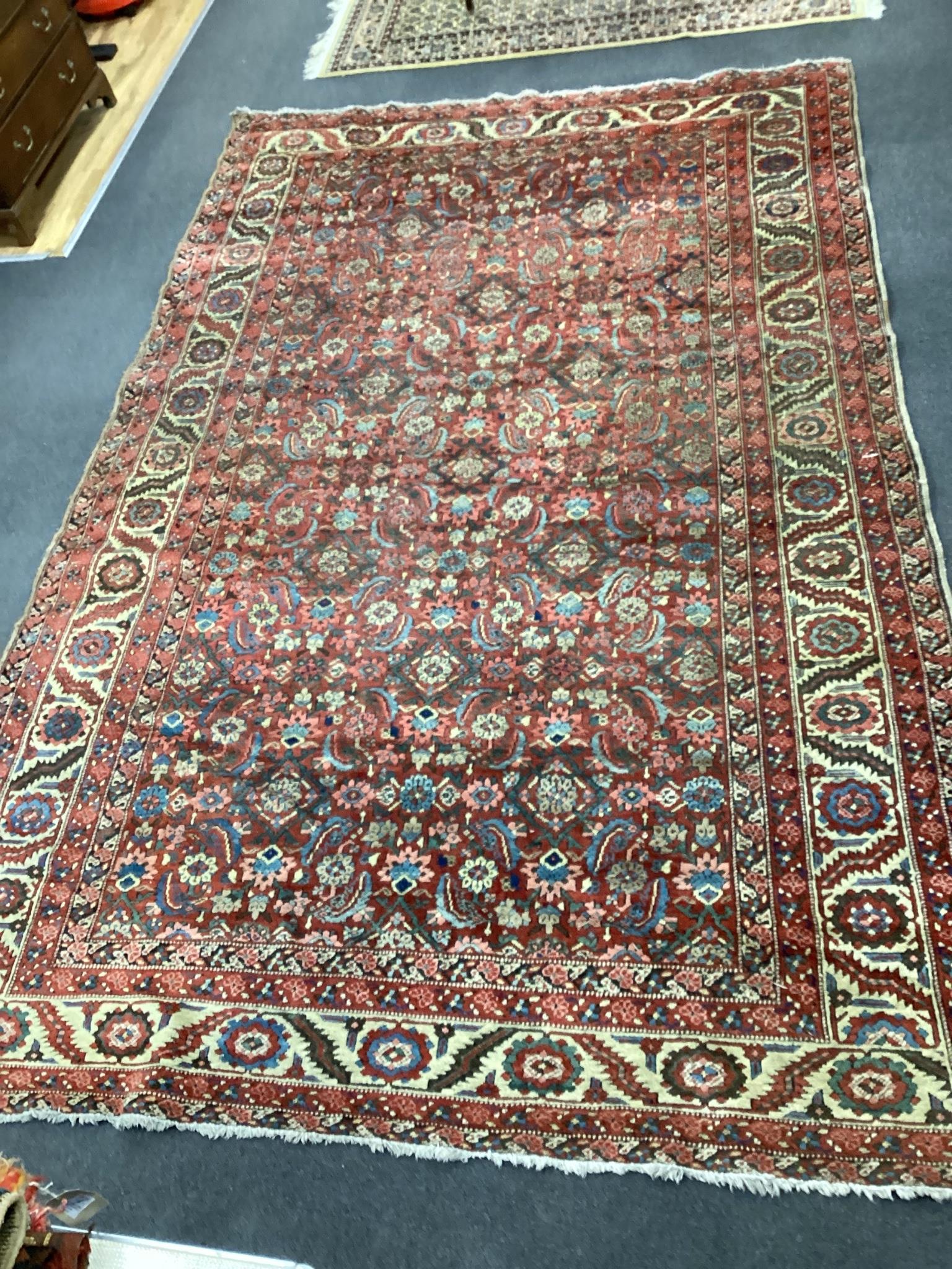 A North West Persian brick red ground carpet, 340 x 216cm